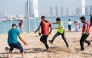 Participants playing football at Katara beach.