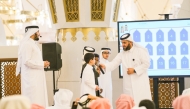Officials with students during the event at Imam Muhammad bin Abdul Wahhab Mosque.