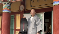 This picture taken on on February 12, 2026 shows Venerable Hosan, head monk of Bongsunsa Temple, posing for a photo with his snowboard during an interview at the temple in Namyangju. (Photo by YONHAP / AFP) 