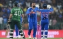 India's Varun Chakravarthy (C) celebrates with wicketkeeper Ishan Kishan after taking the wicket of Pakistan's Abrar Ahmed during the 2026 ICC Men's T20 Cricket World Cup group stage match between India and Pakistan at the R Premadasa Stadium in Colombo on February 15, 2026. (Photo by Ishara S.KODIKARA / AFP)