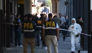 First responders work at the entrance of the Superior Gendarmerie School in Buenos Aires on February 20, 2026, after a mail package exploded. Three people were injured on February 20 by the explosion of a mail package at the Superior Gendarmerie School in Buenos Aires. (Photo by Luis Robayo / AFP)