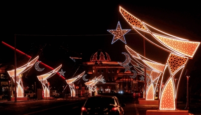 Vehicles move along the road beneath light decorations for Ramadan in Katara Cultural Village in Doha early on February 23, 2026. (Photo by Karim Jaafar / AFP)
