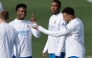 Real Madrid's Brazilian forward #07 Vinicius Junior (L) talks with Real Madrid's French forward #10 Kylian Mbappe (R) during a training session on the eve of their UEFA Champions League knockout round play-off second leg football match against SL Benfica at Santiago Bernabeu Stadium at Real Madrid Sports City in Valdebebas, in the outskirts of Madrid on February 24, 2026. (Photo by Oscar DEL POZO / AFP)