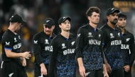 New Zealand's captain Mitchell Santner (3R) walks off the ground with his teammates following their win at the R Premadasa Stadium in Colombo on February 25, 2026. (Photo by Dibyangshu Sarkar / AFP)