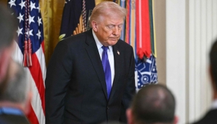 US President Donald Trump departs the stage after hosting a Medal of Honor ceremony in the East Room of the White House on March 2, 2026, in Washington, DC. (Photo by SAUL LOEB / AFP)