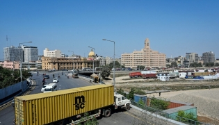 A truck troller is parked to block the road leading to the US Consulate in Karachi on March 2, 2026. Photo by Asif Hassan / AFP
