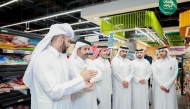 Minister of Commerce and Industry H E Sheikh Faisal bin Thani bin Faisal Al-Thani along with other officials during a visit at a retail outlet.