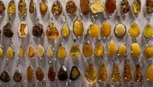 This photo shows jewellery made from natural Baltic amber, on sale at an amber shop on Mariacka Street in Gdansk, Poland on March 10, 2026. (Photo by Wojtek RADWANSKI / AFP)