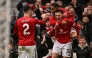 Manchester United's Slovenian striker #30 Benjamin Sesko (R) celebrates with Manchester United's Brazilian striker #10 Matheus Cunha (top R) and teammates after scoring his team's third goal during the English Premier League football match between Manchester United and Aston Villa at Old Trafford in Manchester, north west England, on March 15, 2026. (Photo by Oli SCARFF / AFP)