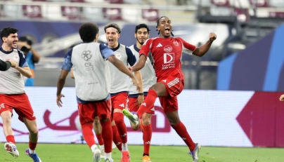 Al Arabi's Isaac Lihadji (right) celebrates with teammates.
