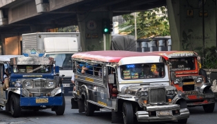 Jeepneys ply their route along a street in Manila on March 23, 2026.Photo by Ted ALJIBE / AFP