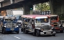 Jeepneys ply their route along a street in Manila on March 23, 2026.Photo by Ted ALJIBE / AFP