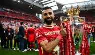 (Files) Liverpool's Egyptian striker #11 Mohamed Salah celebrates with the Premier League trophy on May 25, 2025. (Photo by Paul Ellis / AFP)