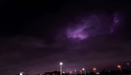 Lightning streaks across the sky during a thunderstorm over Doha on March 25, 2026. Photo by Karim JAAFAR / AFP