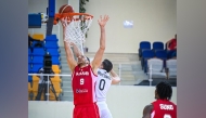 Al Arabi's Elmedin Kikanovic (left) shoots to score.