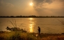 A man fishes along the Mekong River in Vientiane, Laos, March 22, 2026. (Photo by Kaikeo Saiyasane/Xinhua)