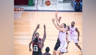 Al Arabi's Elmedin Kikanovic (third right) shoots to score.