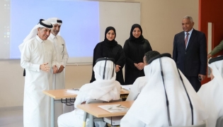 Undersecretary of the Ministry of Education and Higher Education H E Dr. Ibrahim bin Saleh Al-Nuaimi interacts with students in a classroom during his visit to a school.