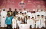 Al Wajba players celebrate with the trophy. Chairman of the Organising Committee Hassan Ali Al Ishaq and Tournament Director Youssef Ali Abdul Noor are also present.   