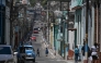 People walk down a street in Matanzas, Cuba, on March 31, 2026. (Photo by Yamil Lage / AFP)