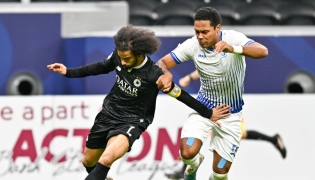 Al Sadd's Akram Afif (left) controls the ball
