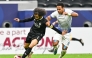 Al Sadd's Akram Afif (left) controls the ball