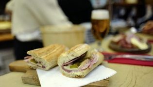This photograph shows a butter, ham, cheese and pickles baguette sandwich at the counter of Le Petit Vendome cafe bistrot in Paris on September 16, 2025. Photo by Ludovic MARIN / AFP