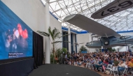 People watch a live broadcast of the return of the Artemis II crew members to Earth at the San Diego Air and Space Museum on April 10, 2026. (Photo by Apu Gomes / AFP)