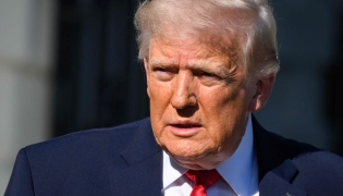 US President Donald Trump walks towards reporters before boarding Marine One to depart from the White House in Washington, DC, on April 11, 2026. (Photo by Mandel NGAN / AFP)