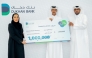 A Dukhan Bank official with the winner of the Thara'a campaign.