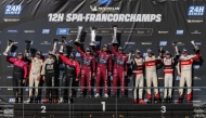 Team Qatar drivers Abdullah Al-Khelaifi, Ahmed Al-Emadi and Faisal Al-Yafei (centre) celebrate on the podium. 