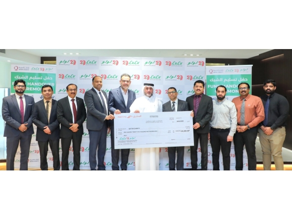 Regional Director of LuLu Hypermarket Qatar, Shanavas P M, presenting a cheque to Deputy Director of Donor Relations at Qatar Charity, Amer Mohammed AlBesiri.