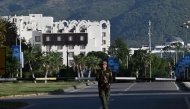 A policer officer stands guard near the Serena Hotel at the Red Zone area in Islamabad on April 22, 2026. (Photo by Aamir Qureshi / AFP)