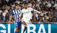 Real Madrid's English midfielder #05 Jude Bellingham fights for the ball with Alaves' Spanish midfielder #04 Denis Suarez during the Spanish league football match between Real Madrid CF and Deportivo Alaves at the Santiago Bernabeu stadium in Madrid on April 21, 2026. (Photo by Pierre-Philippe MARCOU / AFP)