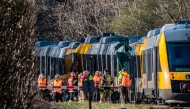 DENMARK-TRANSPORT-RAILWAY-ACCIDENT
Rescue workers stand near two trains that collided between the towns of Hillerod and Kagerup, north of Copenhagen, leaving many injured, on April 23, 2026. The accident happened between the towns of Hillerod and Kagerup, about 40 kilometers (25 miles) from Copenhagen. 
(Photo by Steven Knap / Ritzau Scanpix / AFP) / Denmark 