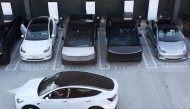 Tesla electric vehicles, including the Cybertruck, charge at stations during the opening of the Tesla Diner and Drive-In restaurant and Supercharger on Santa Monica Blvd in the Hollywood neighborhood Los Angeles, California on July 21, 2025. Photo by Patrick T. Fallon / AFP