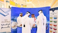 Visitors interacting with an MoI representative at the exhibition.