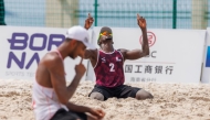 Qatar's Ahmed Tijan (right) celebrates during the match against Iran.