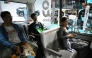 Visitors try out a WeRide autonomous vehicle at the Beijing Auto Show in Beijing on April 26, 2026. (Photo by Greg Baker / AFP)