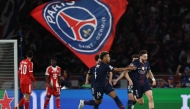 Paris Saint-Germain's Georgian forward #07 Khvicha Kvaratskhelia (R) celebrates with Paris Saint-Germain's French midfielder #14 Desire Doue after scoring his team first goal during the UEFA Champions League semi-final first leg football match between Paris Saint-Germain (PSG) and Bayern Munich at the Parc des Princes in Paris on April 28, 2026. (Photo by Anne-Christine POUJOULAT / AFP)