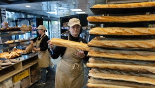 An employee works in a bakery in Quimper, western France, on May 1, 2026. Photo by Fred TANNEAU / AFP