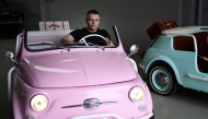 Owner of the Officine Gentile garage, Giovanni Gentile sits at the wheel of a model of a Fiat 500 Jolly Lido at his workshop in Turin on April 30, 2026. (Photo by Marco Bertorello / AFP)