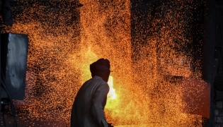 A labourer works at an iron factory in Lahore on April 30, 2026. (Photo by Arif ALI / AFP)
