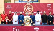 Qatar Basketball Federation, Al Arabi and Al Sadd officials, along with players pose for a photo.