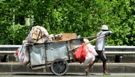 A door-to-door waste collector pushes his cart in front of a house in Jakarta on May 4, 2026. (Photo by Bay Ismoyo / AFP)
