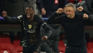 Paris Saint-Germain's Spanish head coach Luis Enrique (R) and his players including Paris Saint-Germain's French forward #10 Ousmane Dembele (L) celebrate after the UEFA Champions League second-leg, semi-final football match between FC Bayern Munich and Paris Saint-Germain (PSG) in Munich, southern Germany on May 6, 2026. (Photo by Odd ANDERSEN / AFP)