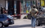 Police stand in a cordoned off area near a bank where suspects have taken multiple hostages in the western German town of Sinzig, on May 8, 2026. (Photo by Thomas Frey / DPA / AFP) 