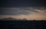 (Files) Image of merchant ships on the horizon in front of the port of El Callao in Lima on November 18, 2023. (Photo by Ernesto Benavides / AFP)