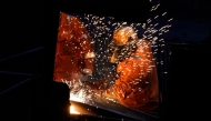 (Files) Workers in the rail and sections hot end rolling mill at the British Steel site in Scunthorpe, Lincolnshire, eastern England on April 17, 2025. (Photo by Danny Lawson / Pool / AFP)
 