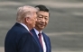 China's President Xi Jinping (R) looks at US President Donald Trump during a welcome ceremony at the Great Hall of the People in Beijing on May 14, 2026. (Photo by Brendan Smialowski / AFP)